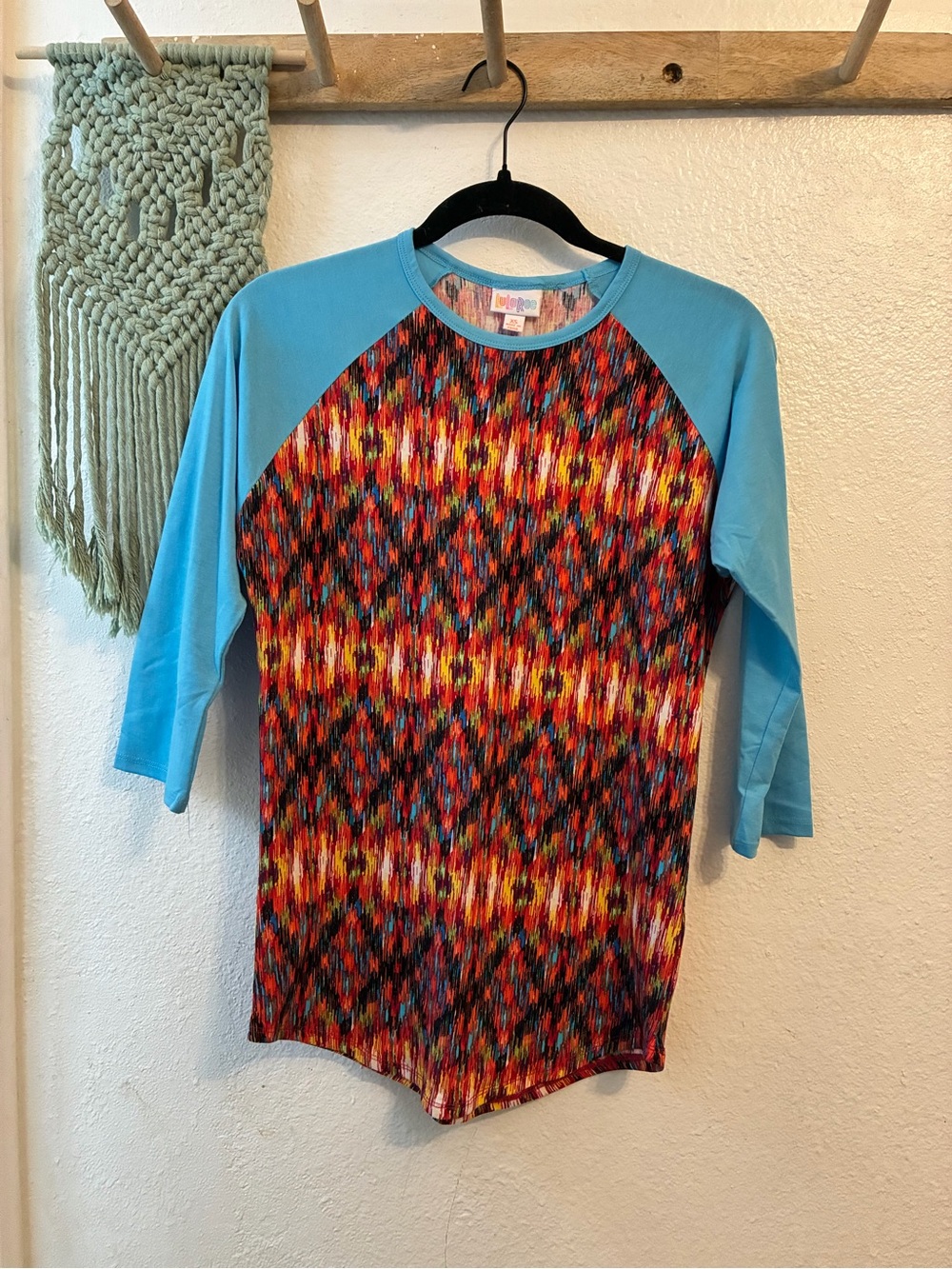 LuLaRoe Multicolor Ikat-Pattern Raglan Top with Aqua Sleeves